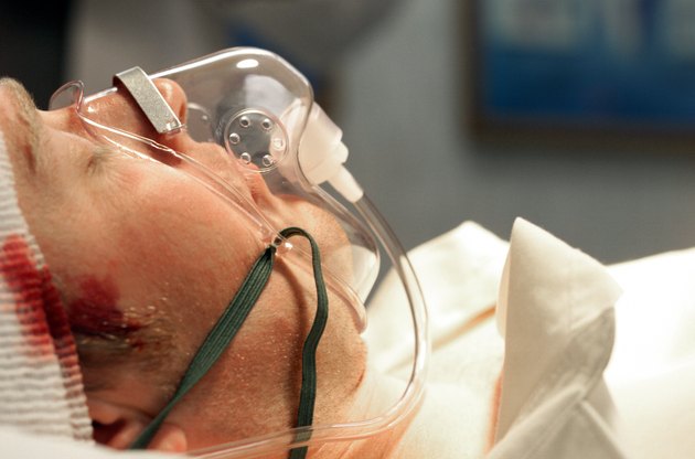 close up of caucasain male patient with a head trauma and an oxygen mask