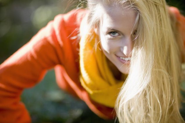 Close-up of young woman doing push-ups outdoors