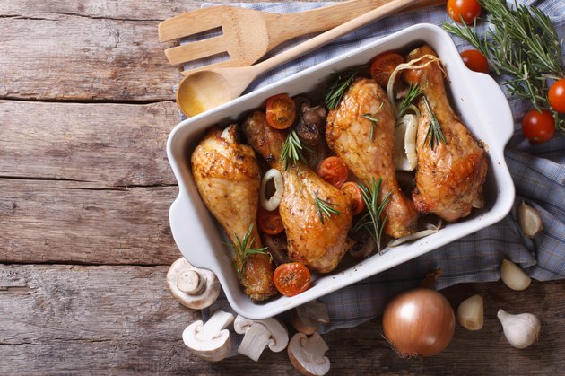 Baked chicken legs with mushrooms and vegetables. horizontal top