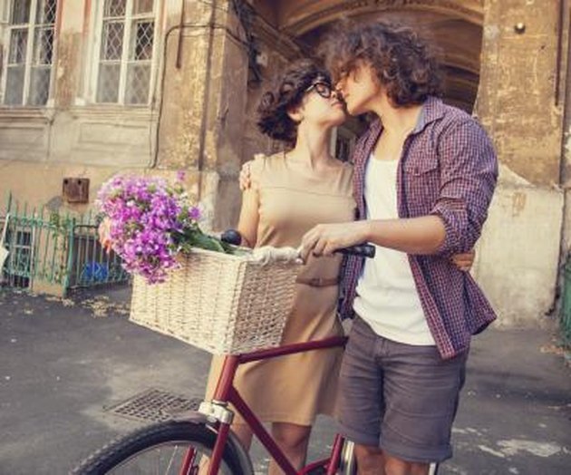 Couple with bike near house.