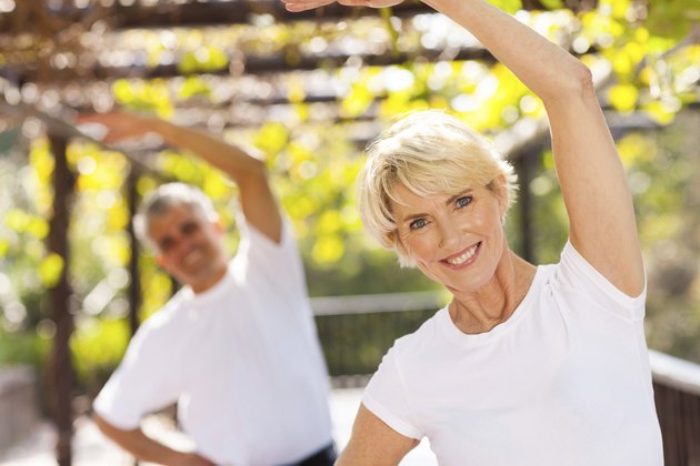 senior woman exercising with husband outdoors