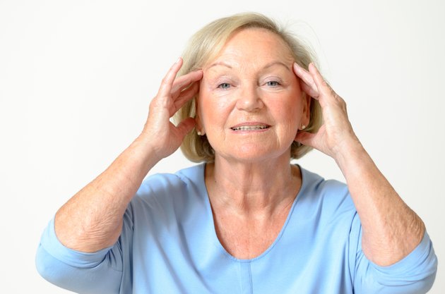 Senior woman showing her face, effect of aging