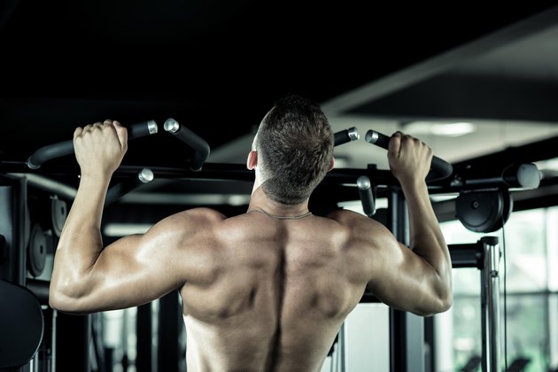 Man doing pull ups in gym