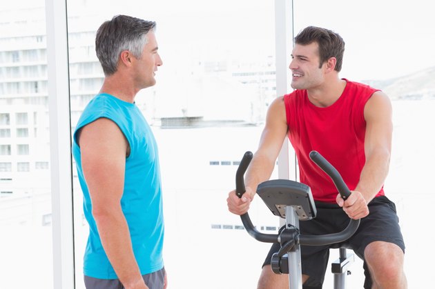 Trainer with man on exercise bike
