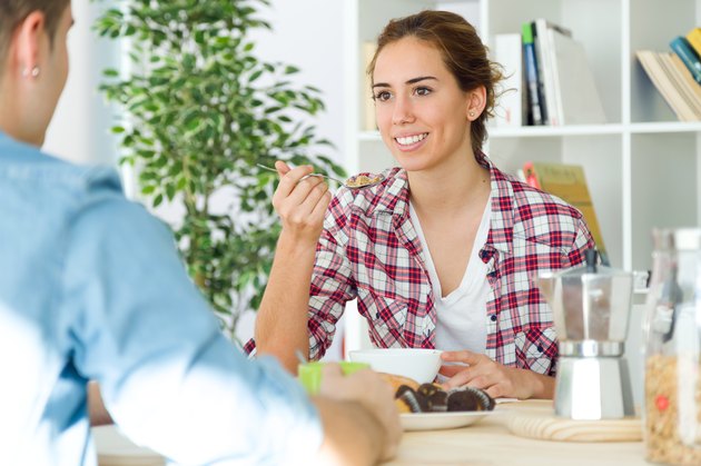 Beautiful young couple enjoying breakfast in their new home.