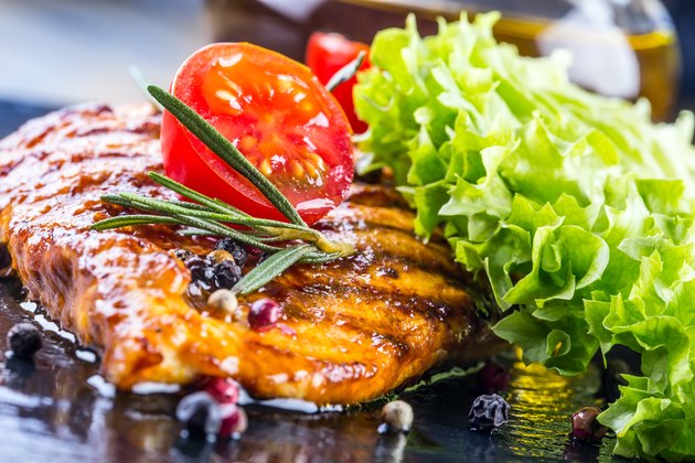 Steak chicken breast on granit board.