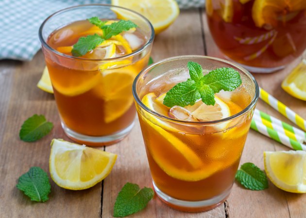 Refreshing homemade lemon iced tea on a wooden table