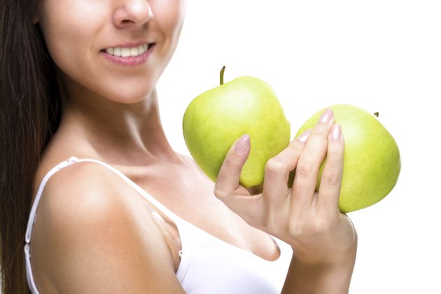 Healthy lifestyle - woman's hands, two beautiful green apple