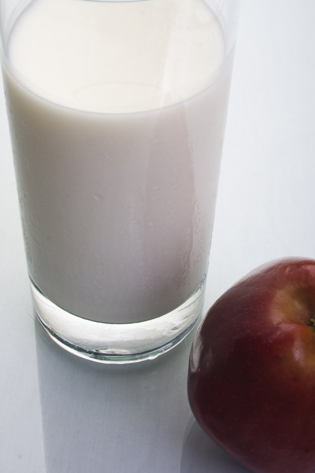 Glass of milk with an apple, studio shot