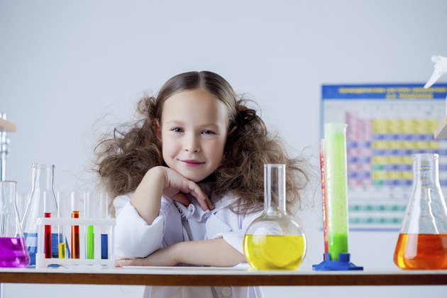Portrait of smiling adorable girl posing in lab