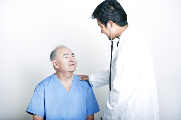 A young Doctor comforting a Senior adult patient
