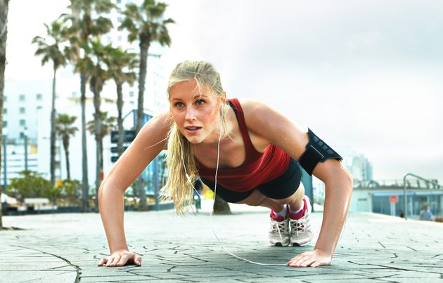 lady doing push ups by the board walk