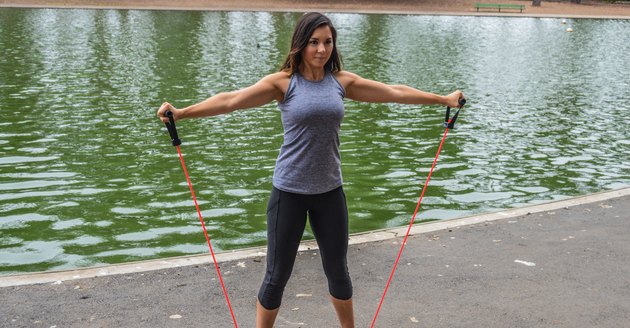 Athletic skinny woman using resistance bands