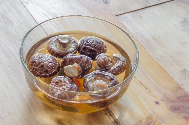 Dried shiitake mushroom in transparent bowl with water