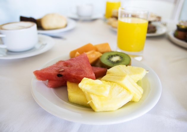 Plate of fruit and orange juice