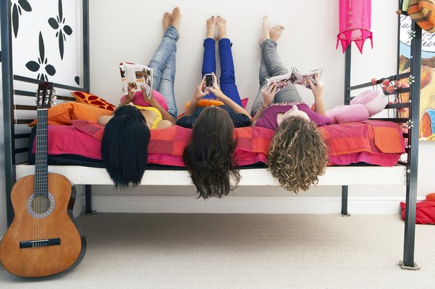 three girls lying on bed