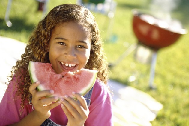 Portrait of a girl holding a slice of watermelon