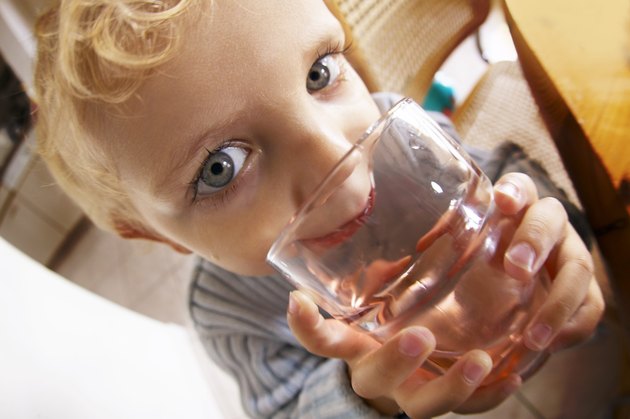 Boy Drinking Out Of Glass