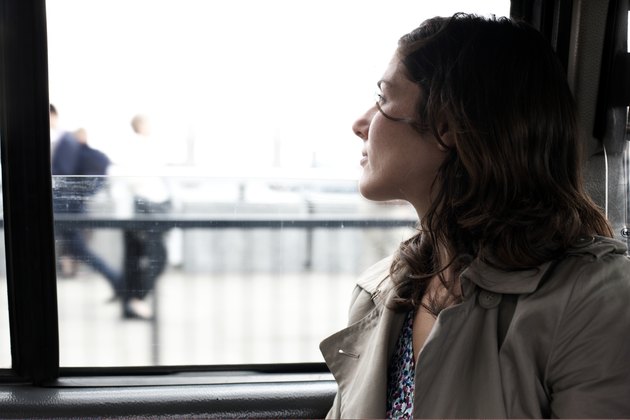 Woman travelling in taxi looking out of window