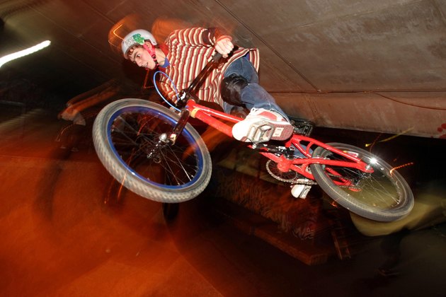 Low angle view of a teenage boy performing stunts on a bicycle