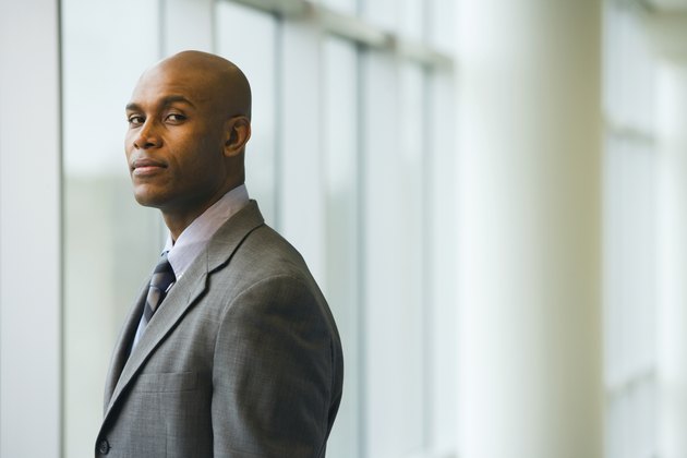 African businessman standing next to window