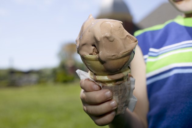 Child's hand holding ice cream cone