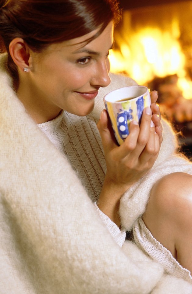 Woman by fireplace