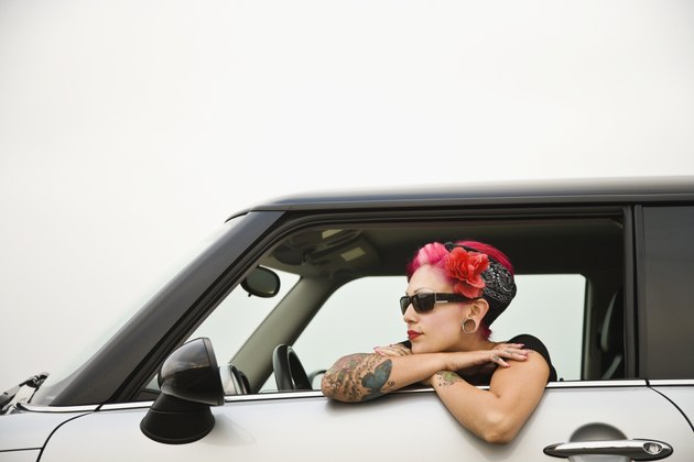 Tattooed Hispanic woman in car