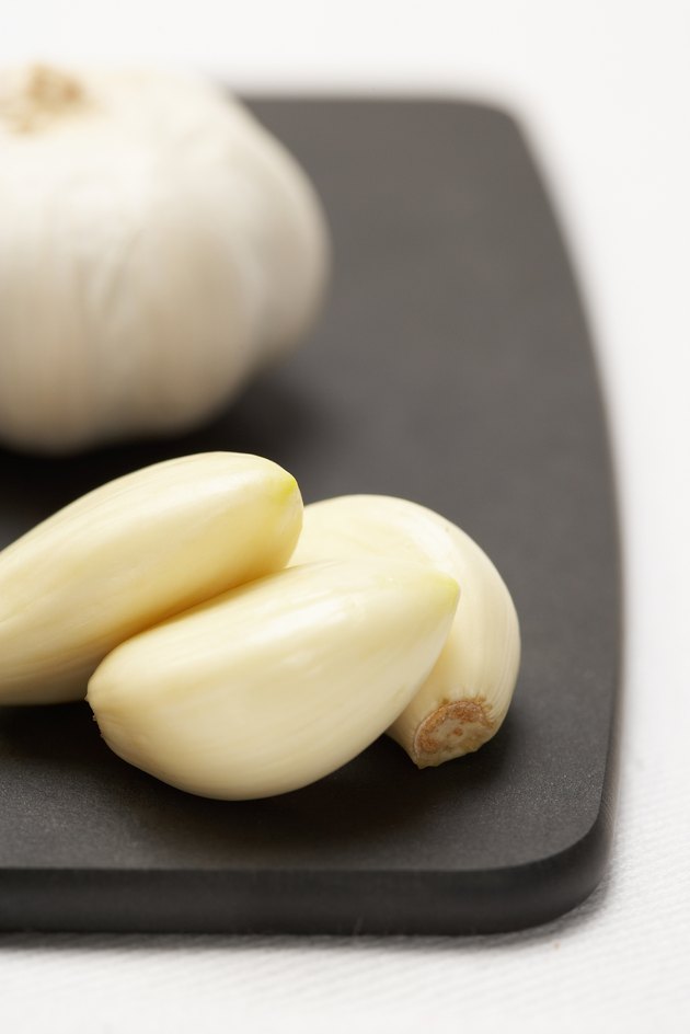 Garlic cloves and bulb on cutting board