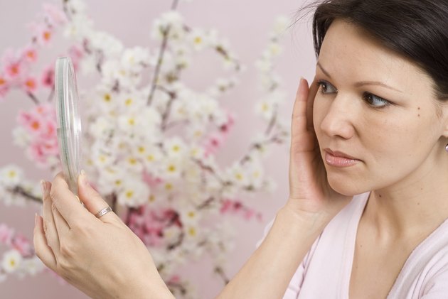 woman looks in the mirror