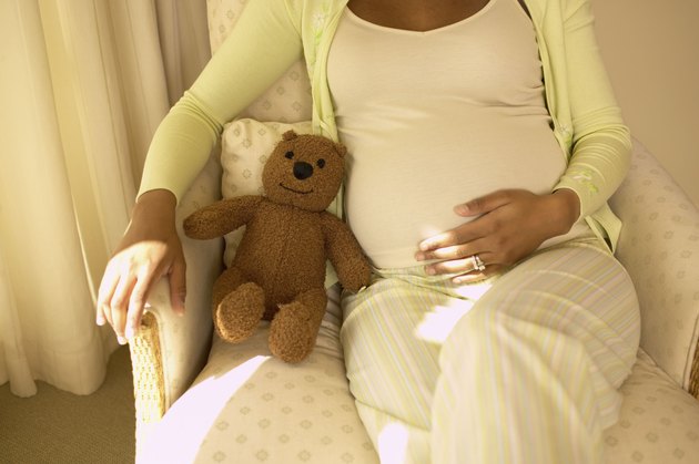 Pregnant woman with a teddy bear