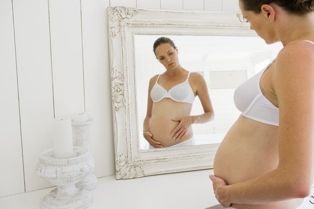Pregnant woman by mirror