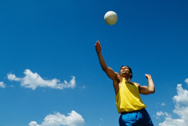 Man serving volleyball