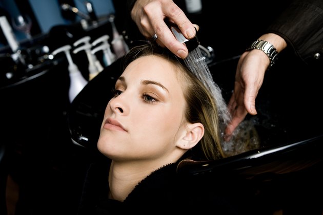 Woman getting hair washed in beauty salon