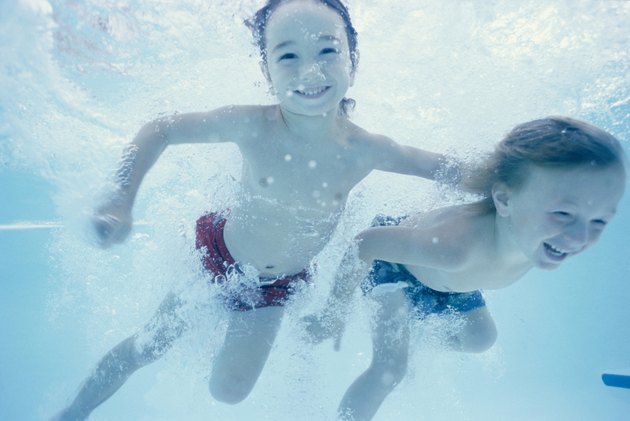 Two children swimming underwater