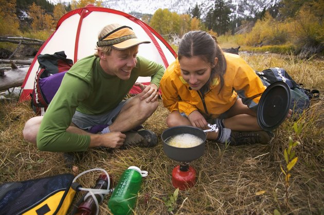 People cooking at campsite