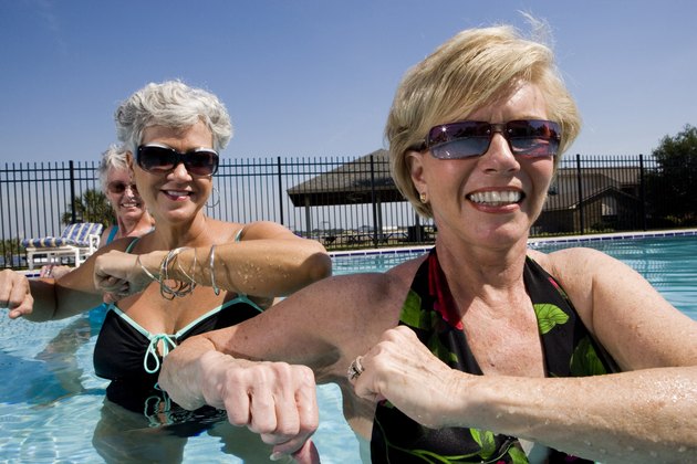 Cheerful senior women exercising in swimming pool