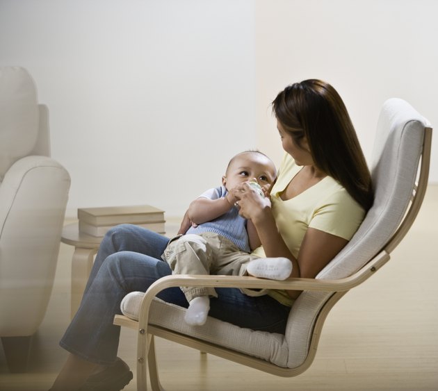 Asian mother feeding baby
