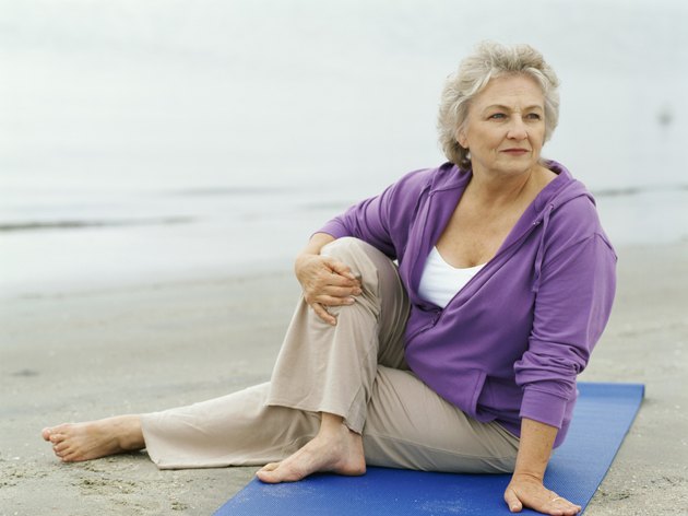 senior woman exercising on the beach