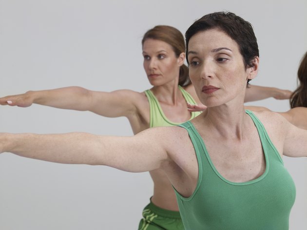 Three mature women, performing yoga