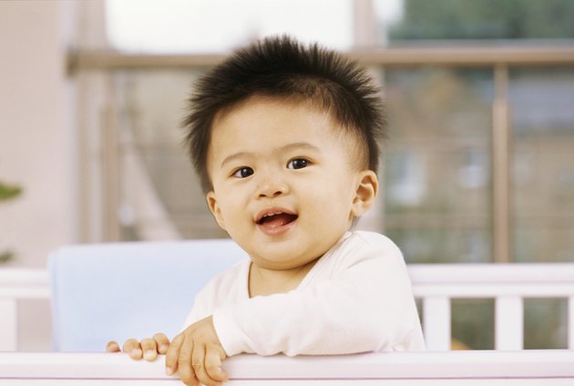 portrait of a baby boy in a crib