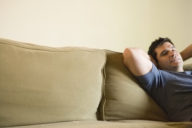 Mature man relaxing on sofa