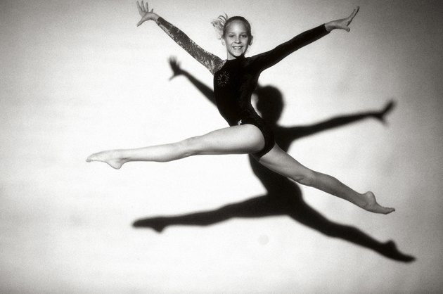 Portrait of a female teenage gymnast jumping