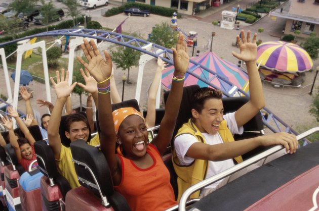 Group of teenagers riding a rollercoaster