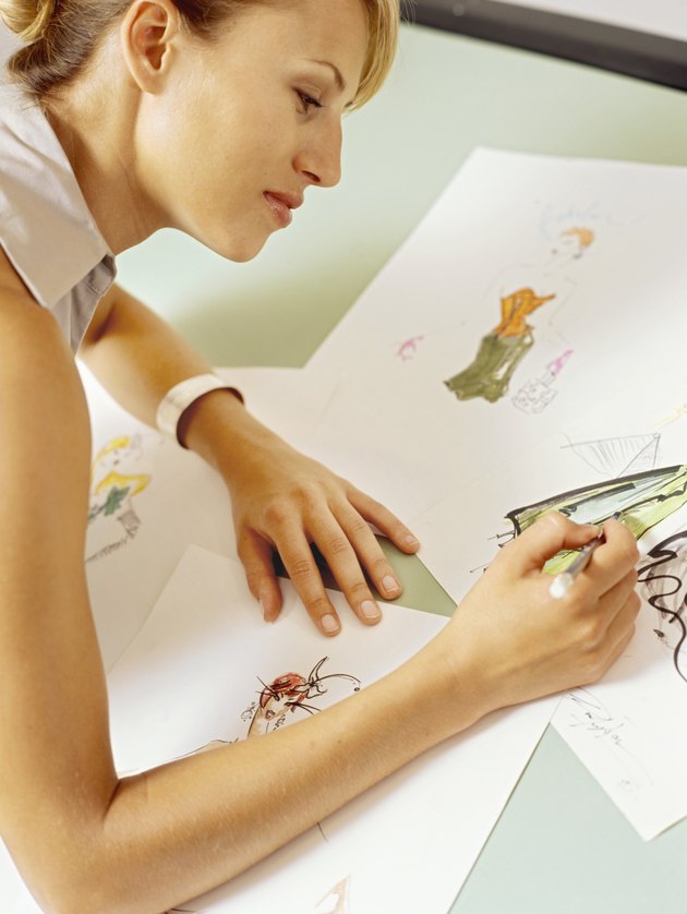 Side profile of a fashion designer sketching