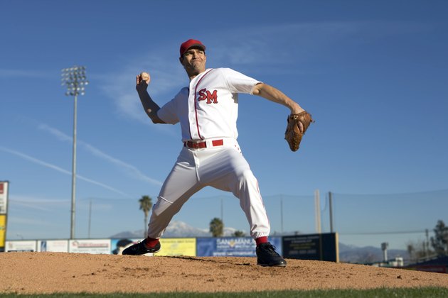 USA, California, San Bernardino, baseball pitcher throwing pitch, outdoors