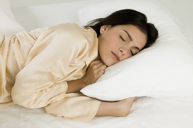 Young woman sleeping on a bed