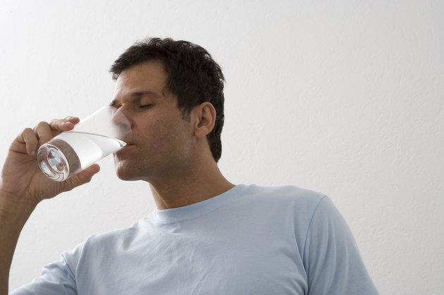 Mature man drinking water