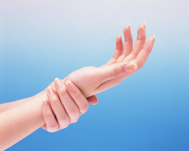 Woman putting her wrist on the other hand