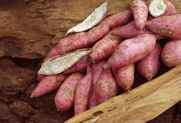 Old potatoes on wooden